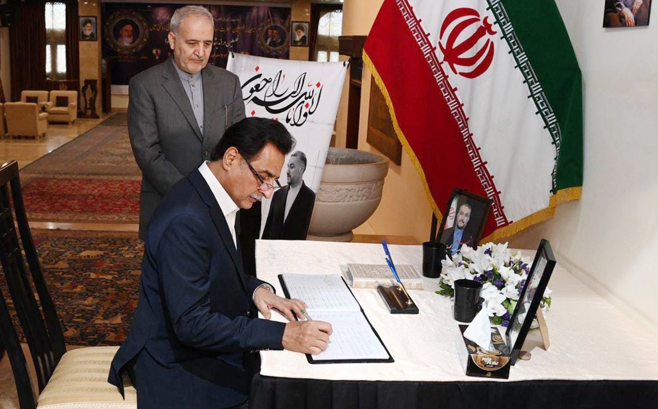 Speaker National Assembly Sardar Ayaz Sadiq inscribing his remarks in a condolence book at the Iranian Embassy.